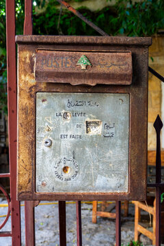 An antique rusted mailbox bears the cedar tree emblem of the Lebanese postal service, North Governorate, Tripoli, Lebanon