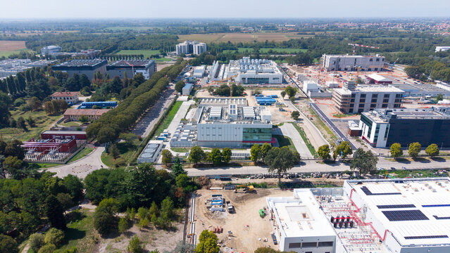 Aerial view of the Equinix ML5 data center complex featuring multiple industrial buildings, construction sites with cranes, and surrounding greenery in Castelletto, Lombardia, Italy.