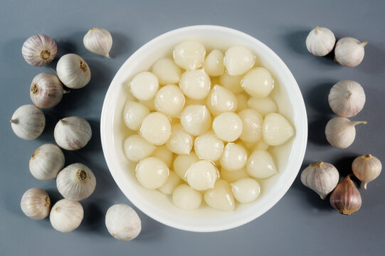 pickled solo garlic in white bowl