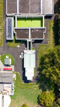 Aerial view of the rectangular aeration tanks and industrial water filtration system at a wastewater treatment plant in Milan, Lombardy, Italy.