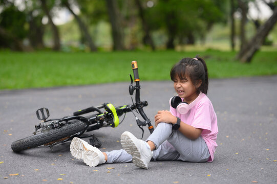 A girl is riding a bicycle in the park on a holiday.