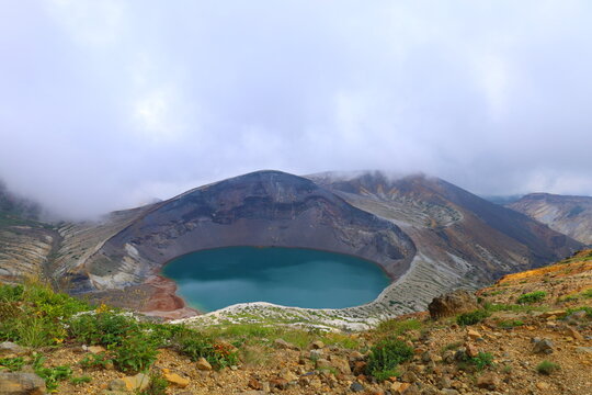 Mysterious emerald green Okama crater lake at Mount Zao in Japan
