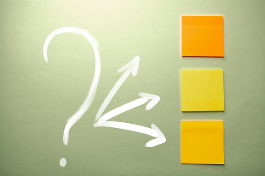 Question mark with arrow and yellow sticky notes
