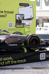 Fototapeta premium NEW YORK, USA – SEPTEMBER 16, 2026: a Formula 1 car display in Times Square with sponsor branding and promotional signage for travel and business software.