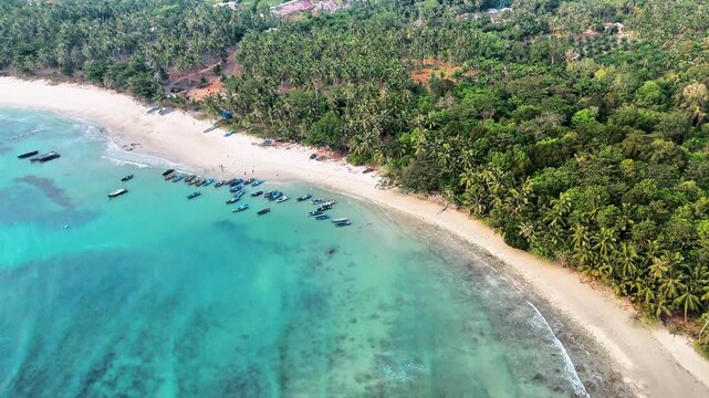 serene tropical beach retreat with peaceful coastline, colourful fishing boats and lush tropical forest offering ultimate relaxation escape