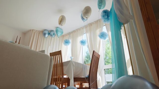 Balloons on the floor decorated birthday party room camera movement low angle