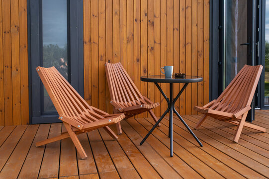  wooden folding lounge chairs and coffee table outdoor on terrace no people