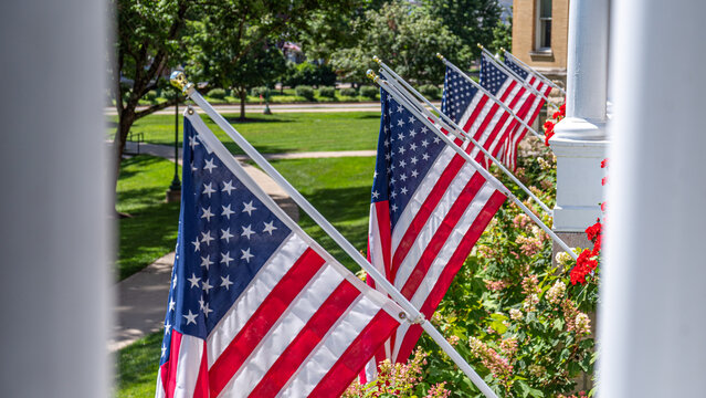 American flags displayed beside a landscaped veranda