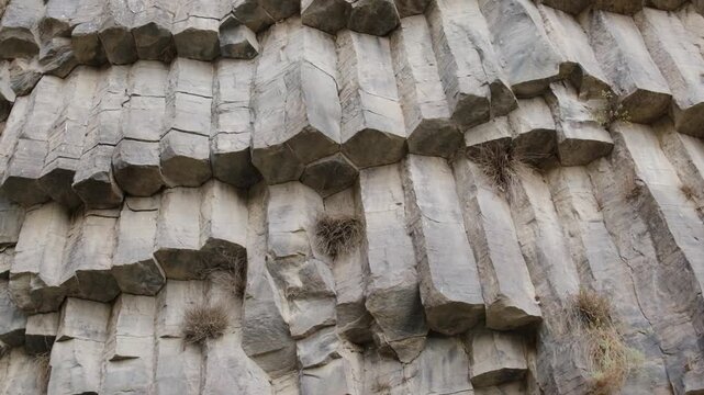 Symphony of Stones, Armenia. Unique hexagonal stone formations reveal intricate textures and shapes, highlighting natural geological features in a rugged outdoor setting