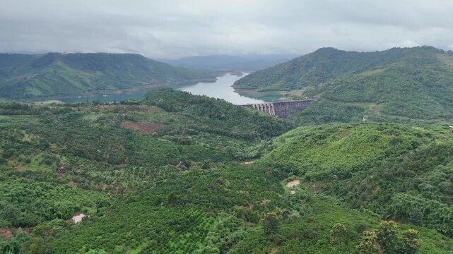 Aerial view of Ta Dung Lake with green hills and Dam. Dak Nong, central Vietnam.