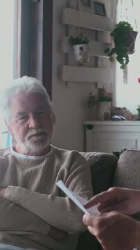 Mature man with a worried expression listening to an advisor explaining bills and expenses, illustrating the challenges of managing household finances and retirement savings