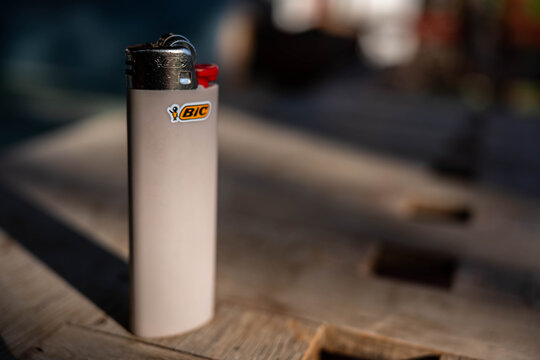 Miercurea Ciuc, Romania- 17 September 2026: Light brown Bic cigarette lighter on wooden table.