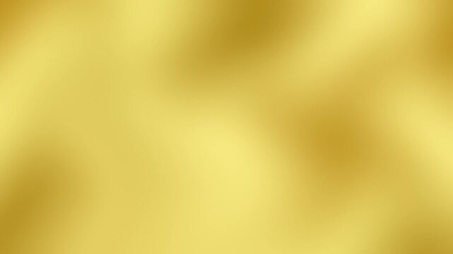 A smooth and luxurious abstract gold gradient background featuring soft light bokeh effects and a blurred metallic texture for elegant designs.
