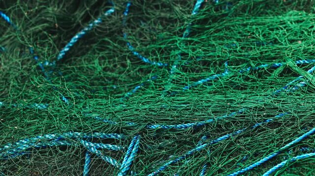Close-up of folded and ready-to-use synthetic fishing nets, fishing gear for catching sea fish. the global problem of fishing nets.