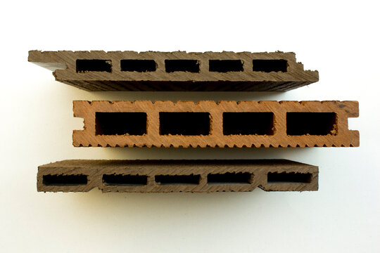 Top view of composite wood decking board cross section profile samples on white background