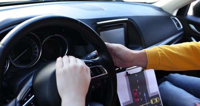 Driving school. Instructor showing student indicator stalk in car, closeup