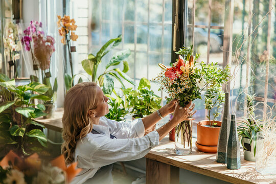 Florist arranging fresh bouquet in flower shop