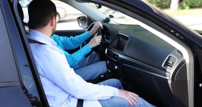 Woman having driving lesson with instructor in car