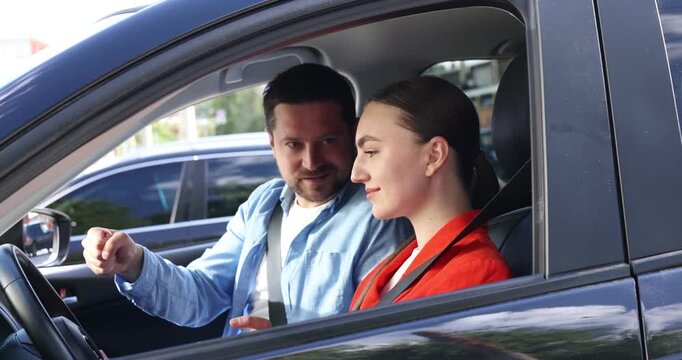 Woman having driving lesson with instructor in car