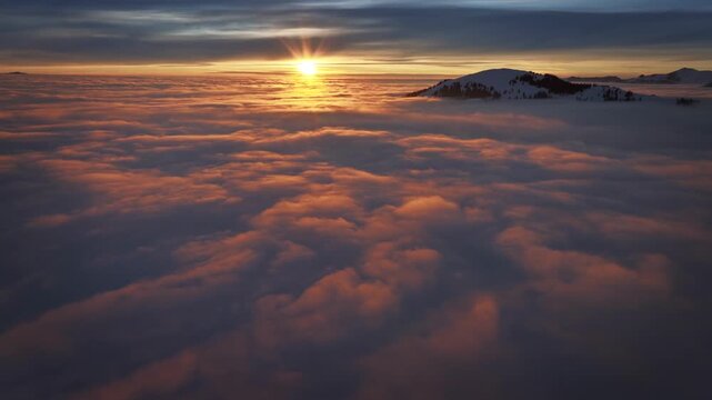 Real video of sea of clouds, flying above, gradually rising, heaven like atmosphere