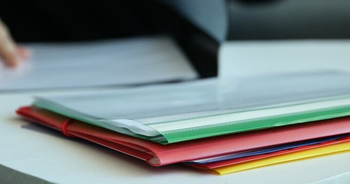 File folders on table and businesswoman, selective focus
