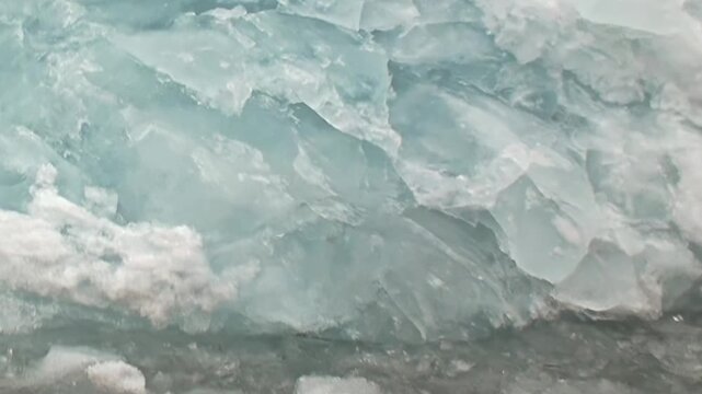 Blue ice and irregular frozen texture fill a close natural view. Visible secondary elements include natural light and surface texture, adding depth and context to the overall composition.