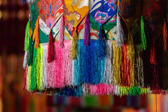Colorful silk tassels decorating a pillar inside Longwu monastery, Tongren County, Longwu, China