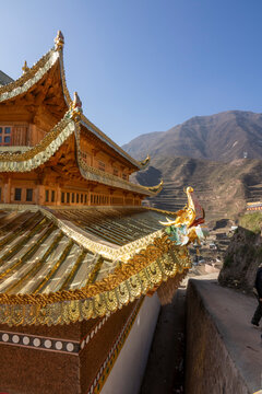 The gilded roof of Bongya monastery overlooks the surrounding mountains, Qinghai Province, Mosele, China