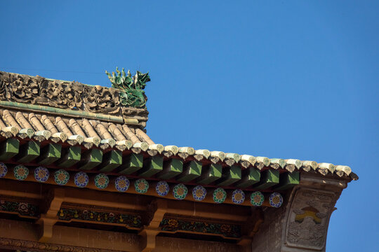 Dragon ornament decorates a roof corner at Dong Gong Guan mansion, Gansu Province, Linxia, China