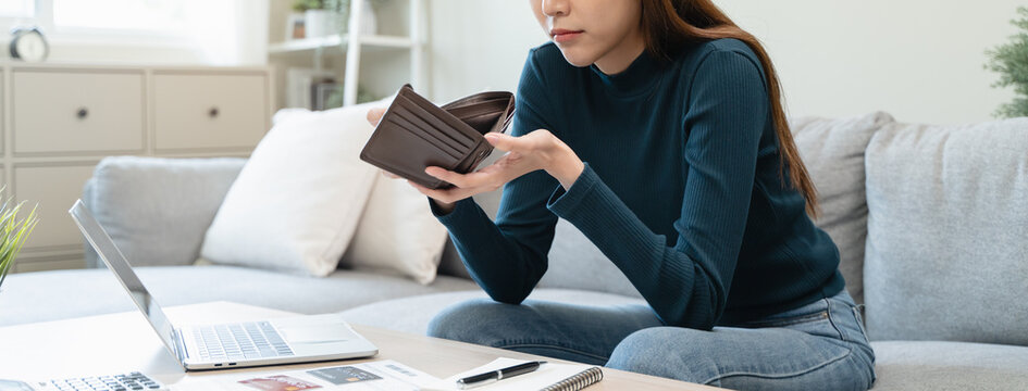 young asian woman cover her face after stressed with monthly bill expenses and credit card debt.