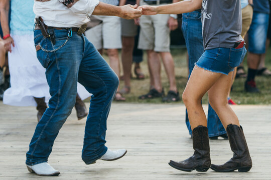 Couple Holding Hands While Line Dancing Two-Step Together
