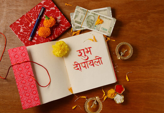 Diwali customs and traditions. 'Shubh Dipavali'  message in hindi written by hand on a  new account book. Warm, festive Diwali photo symbolizing wealth, new begining and light.