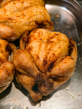 Grilled chickens displayed in a supermarket food deli, showing ready prepared poultry offered for customers in a grocery retail environment