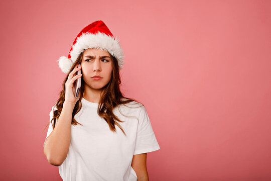 Young woman receiving bad news on christmas call