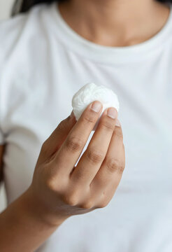 Skincare and beauty routine, woman holding a cotton pad for facial cleansing and makeup removal in a daily hygiene and dermatology wellness