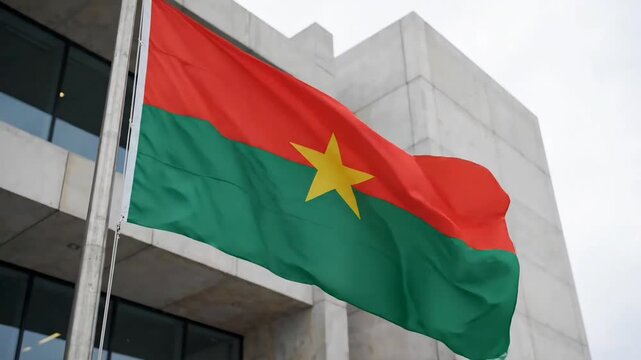 Burkina faso flag fluttering on pole outside official building