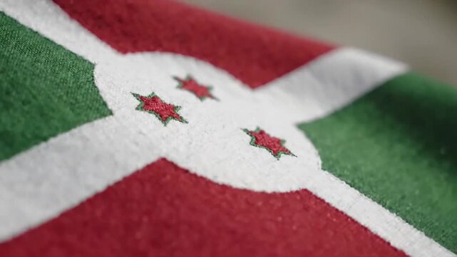 Close up shot of the burundi flag textile fabric with stars