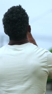 African American man raising fist to sky in triumph outdoors for spiritual victory