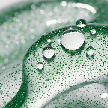 Clear moisturizing gel texture with green chlorophyll micro beads organic cosmetic background