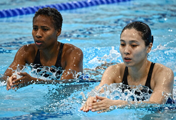 Obraz premium Diversity and inclusion in sports, professional female swimmers training in a pool for competition with focus and determination in a swimming facility