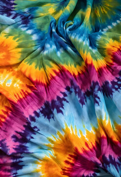 Tie dye fabric background, retro 1960s fashion and hippie culture aesthetic, colorful psychedelic textile pattern with spiral swirl design and soft folds