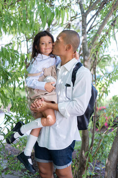 Loving Father Kissing His Daughter Before School