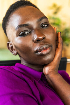 Portrait Of A Relaxed Woman With Short Hair And Purple Shirt.