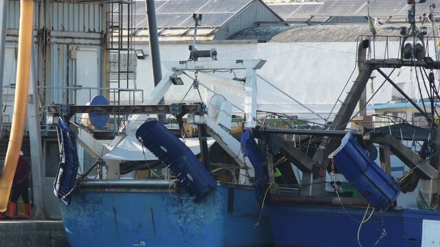 Commercial trawler boats stern and fishing equipment at port