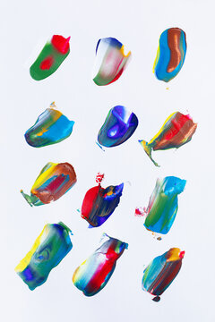 Strokes of multi-colored paint on the surface of paper