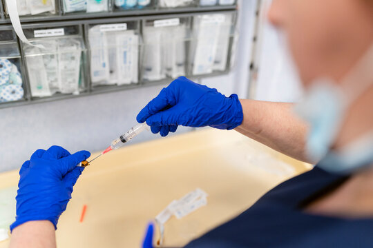 Medical professional preparing vaccine for treatment