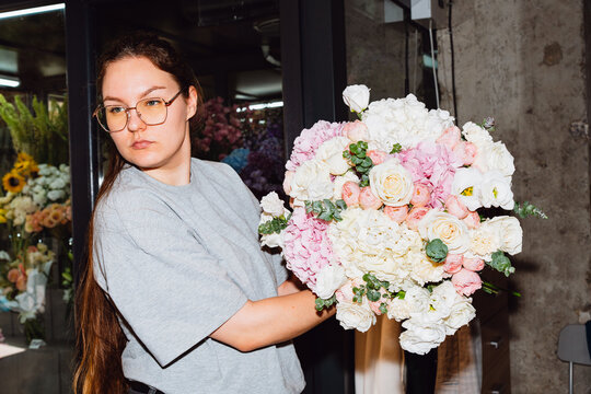 Florist presenting a handmade flower bouquet