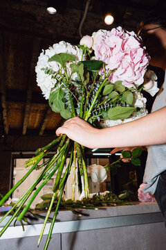 Florist tying a handmade flower bouquet
