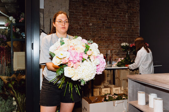 Florist holding a fresh flower bouquet