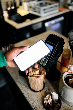Customer Paying with Smartphone via NFC Terminal at Cafe Counter